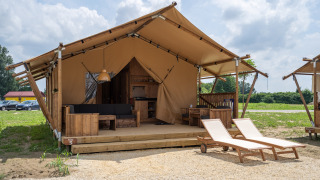 SunLodge Taiga: Spacious glamping tent with wooden deck, outdoor seating, and two sun loungers.