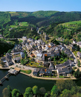 Vista aérea de la pintoresca localidad de Larochette en Mersch, Luxemburgo, rodeada de colinas y vegetación.