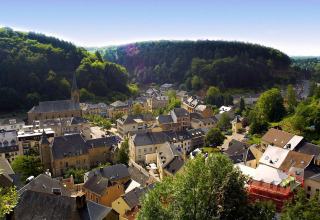 Uitzicht op vakantiepark hu Birkelt Village in Mersch, Luxemburg, omgeven door groene heuvels.