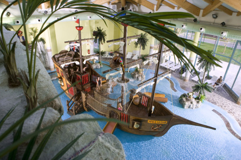 Indoor water park featuring a pirate ship and palm trees at Camping Terme Catez holiday park, Lower Sava, Slovenia.
