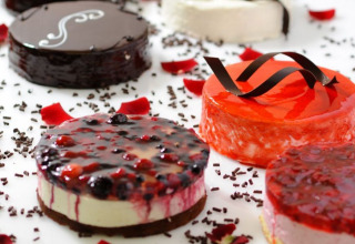 An assortment of glazed mini cakes with berries and chocolate, served at Camping Terme Catez, Slovenia.