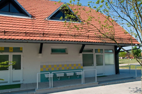 Lavandini esterni e edificio con tetto in tegole al Camping Terme Catez, parco vacanze in Slovenia, giornata di sole.