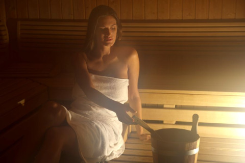 Woman relaxing in sauna with towel at Camping Terme Catez holiday park, Lower Sava, Slovenia.