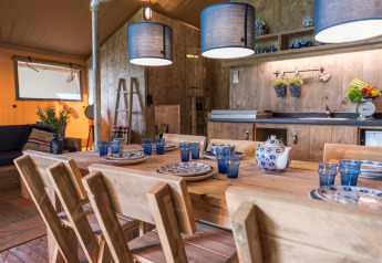 Dining and kitchen area inside luxury safari tent SunLodge Pamoja&Kambi at Camping Terme Catez in Slovenia.