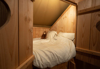 Cozy sleeping area inside SunLodge Pamoja&Kambi safari tent at Camping Terme Catez in Slovenia.