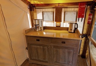 Kitchen area in the SunLodge Jungle safari tent with coffee maker and kettle at Camping Vilanova Park in Spain.