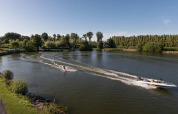 Water-skier being towed by a speedboat on a peaceful lake at Vakantiepark Klein Strand, West Flanders, Belgium.