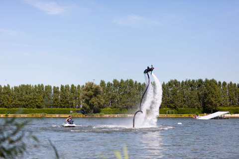 Person flyboarding over water at Vakantiepark Klein Strand holiday park, West Flanders, Belgium