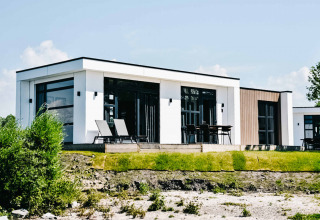 Moderne feriebolig ved MarinaPark Bad Nederrijn i Gelderland, Holland, med udendørs terrassemøbler.