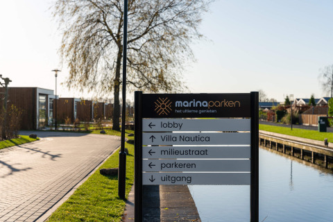 Signpost at MarinaPark Residentie Nieuw Loosdrecht holiday park in North Holland, Netherlands, by canal.
