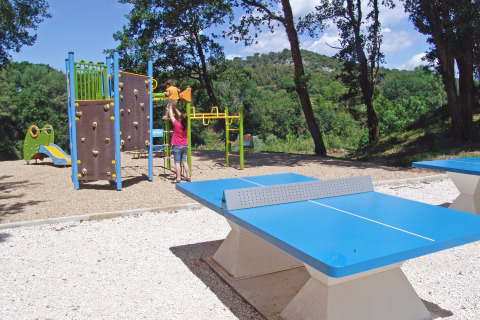 Área de juegos con pared para escalar, tobogán y mesas de ping-pong en Slow Village Provence Occitane, Francia.