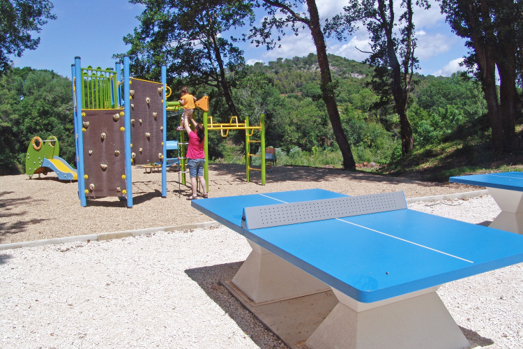 Playground with climbing wall, slide and table tennis tables at Slow Village Provence Occitane, France.