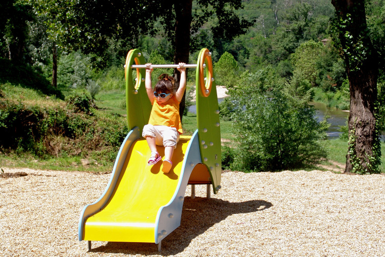 A child plays on a slide in the Slow Village Provence Occitane holiday park in Occitanie, France.