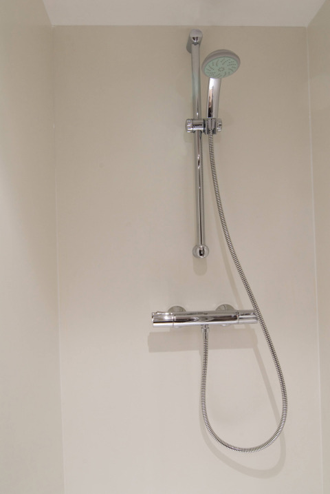 Douche met verstelbare douchekop en chromen mengkraan in het RoyalLodge safaritent te Slow Village Provence Occitane.