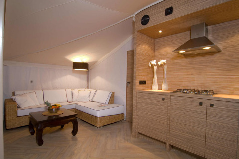 Interieur van het RoyalLodge safaritent met keuken en zithoek bij Slow Village Provence Occitane in Frankrijk.