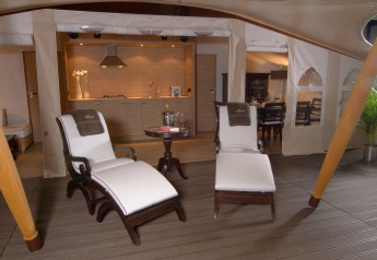 Luxury safari tent interior with elegant loungers and a view of a modern kitchen at Slow Village Provence Occitane.