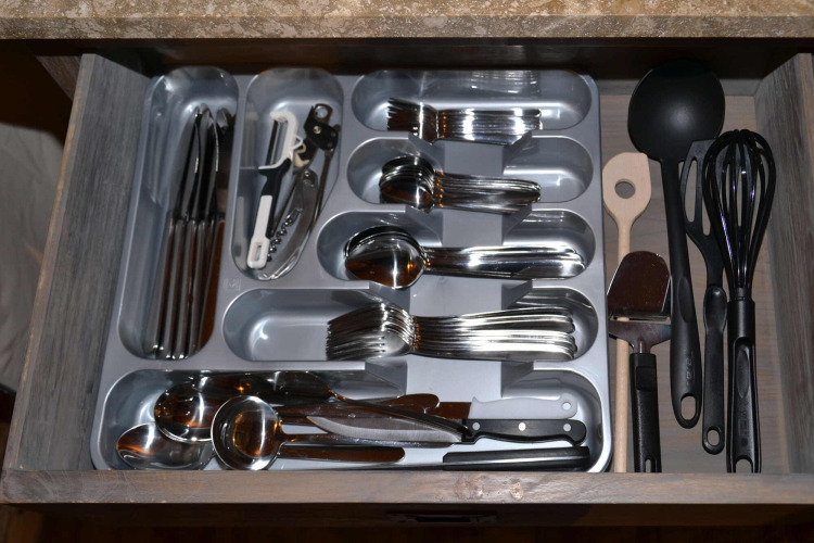 Open drawer with neatly organized cutlery and utensils at SunLodge Safari tent, Slow Village Provence Occitane.