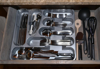 Open drawer with neatly organized cutlery and utensils at SunLodge Safari tent, Slow Village Provence Occitane.