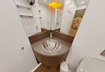 Moderne badkamer met houten wastafel en leeuwenafbeelding in een SunLodge Safari tent, Slow Village Provence.