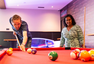 Zwei Personen spielen Billard in einem Ferienpark in Résidence de Leuvert, Nordbrabant, Niederlande.