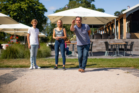 Famiglia gioca a pétanque al parco vacanze Résidence Lichtenvoorde in Gheldria, Paesi Bassi.