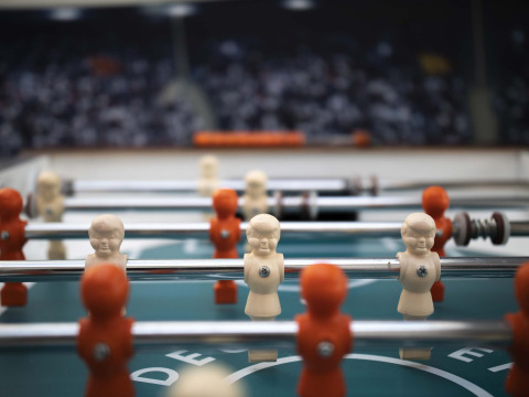 Close-up of a foosball table with white and orange players at Résidence Valkenburg, Limburg, Netherlands.
