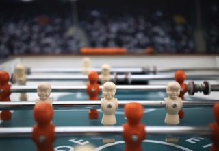 Close-up of a foosball table with white and orange players at Résidence Valkenburg, Limburg, Netherlands.