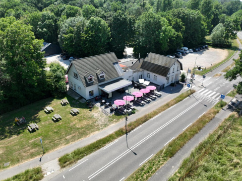 Aerial view of Camping de Boskant in Limburg, Netherlands, with buildings, terraces, and picnic tables.