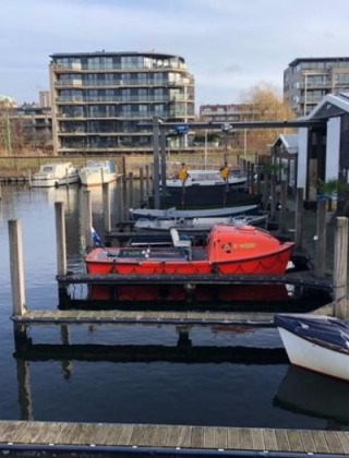 View of boat docks and modern apartments at Marina Parcs - Jachthaven De Hoop in North-Holland, Netherlands.