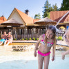 Children play in the paddling pool with water fountains at Resort Veluwe holiday park in Gelderland, Netherlands.