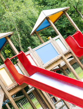 Colorful playground with slides and climbing structures at Camping Het Veen holiday park in Antwerp, Belgium.