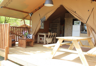 Tienda safari en Lac du Causse, Francia, con terraza de madera, mesa de picnic y zona acogedora.
