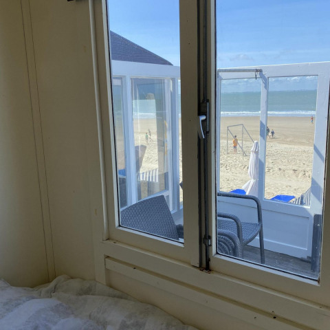 Gezicht vanuit een strandhuisje in Dishoek, Zeeland, Nederland, uitkijkend op strand en zee.