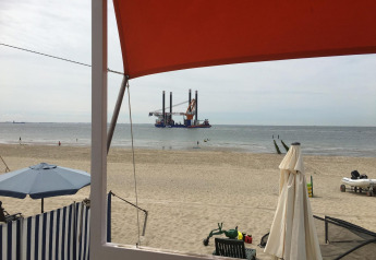 Udsigt fra Beach house Dishoek 345/346 på stranden i Zeeland, Holland, med hav, sand og platform.