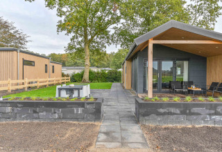 Casa vacanza moderna al Drentse Weelde, Drenthe, Paesi Bassi, con patio, giardino e area salotto esterna.