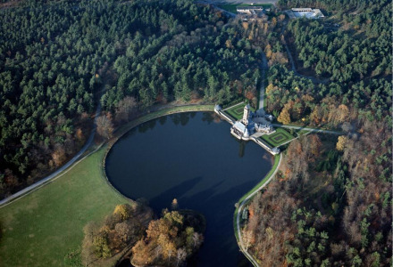 Luftaufnahme eines Schlosses und Sees im Wald in der Nähe von Kootwijk, Gelderland, Niederlande im Herbst.
