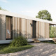 Moderne Waterlodge på Resort de Parel i Holland, omgivet af natur, sø og træer under klar himmel.