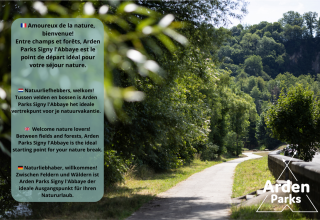 Sendero entre bosques verdes en Arden Parks Signy l'Abbaye, punto ideal para unas vacaciones en la naturaleza.