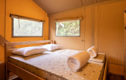 Interior of a bedroom in Safari Tent Dreamer 49 at Arden Parks - Signy l'Abbaye in France.