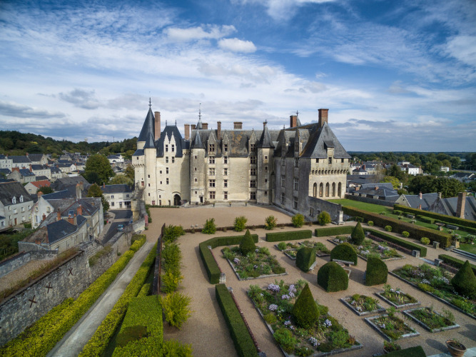 Aerial view of a grand château with formal gardens and surrounding buildings near Rillé, Centre-Val de Loire.