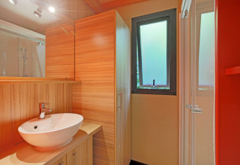 Moderne badkamer met houtdecor, waskom en matraam in Chalet Toronto, Huttopia De Roos, Nederland.