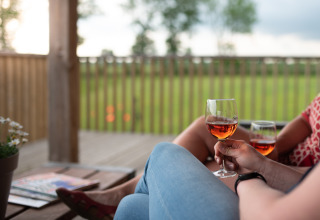 Deux personnes dégustent un verre de vin rosé sur la terrasse d’Ackerlodge à Ruinerwold, Pays-Bas.
