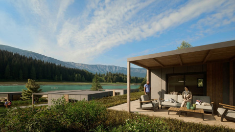 Cabañas glamping junto a un lago en un parque de vacaciones, rodeadas de montañas y bosque, con huéspedes.
