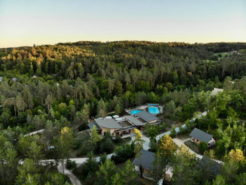 Aerial view of Village Huttopia Lanmary holiday park in Nouvelle-Aquitaine, France, surrounded by forest.