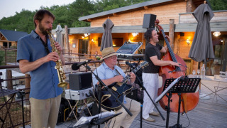 Jazz band performing live music on the terrace at Village Huttopia Sud-Ardèche in Auvergne-Rhône-Alpes, France.