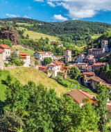 Scenic view of a hillside village surrounded by nature, offering unique glamping holiday accommodations.