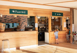 Photo of pizza grill and bar counter at Huttopia La Forêt de Janas holiday park in Provence-Alpes-Côte d’Azur, France.