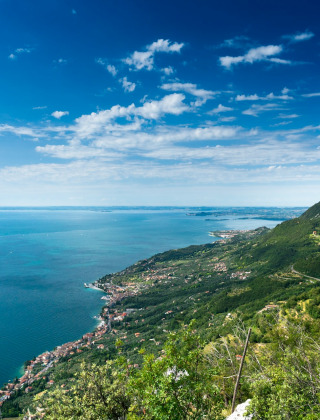Vista del lago de Garda y las colinas verdes cerca de Castelnuovo del Garda, Véneto, Italia, en un día claro.