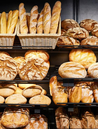 Pan y baguettes recién horneados en estantes de una panadería en un parque vacacional con glamping.