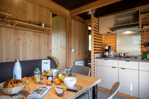Cocina y comedor modernos en el chalet Evasion Vista, con desayuno servido sobre la mesa de madera.